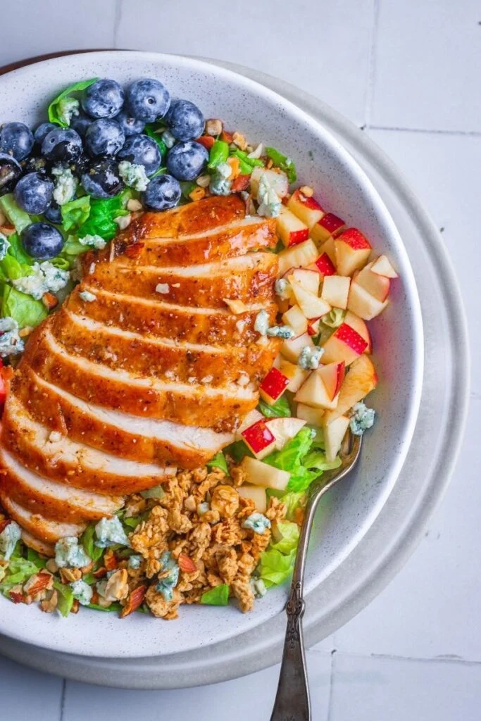 Chicken and fruit salad in a serving dish.