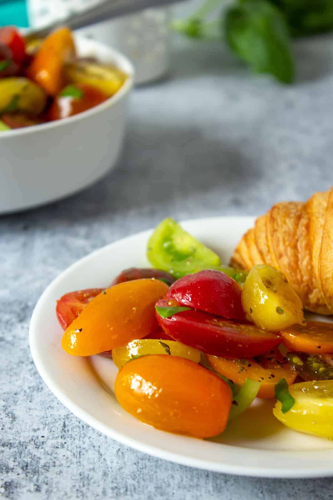 Fresh heirloom tomato salad on a white plate.