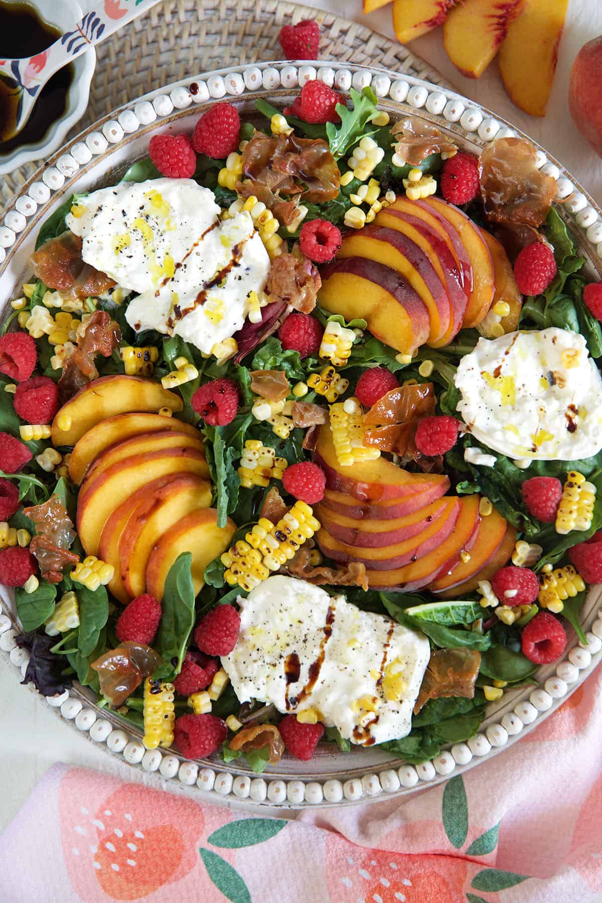 Peach burrata salad in a serving bowl.