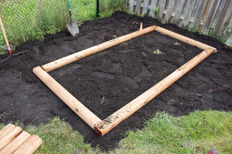 Raised bed garden built from lumber ties.