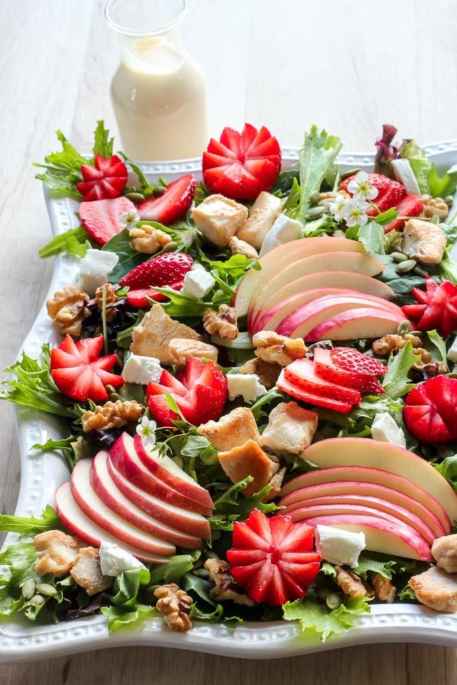 Strawberry and chicken salad on a platter.