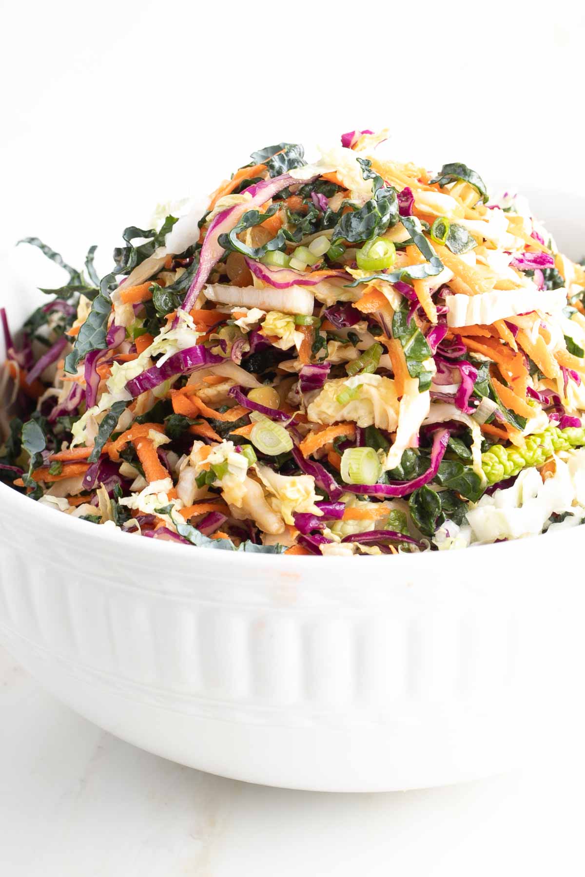 Coleslaw with a ginger miso dressing in a white bowl.