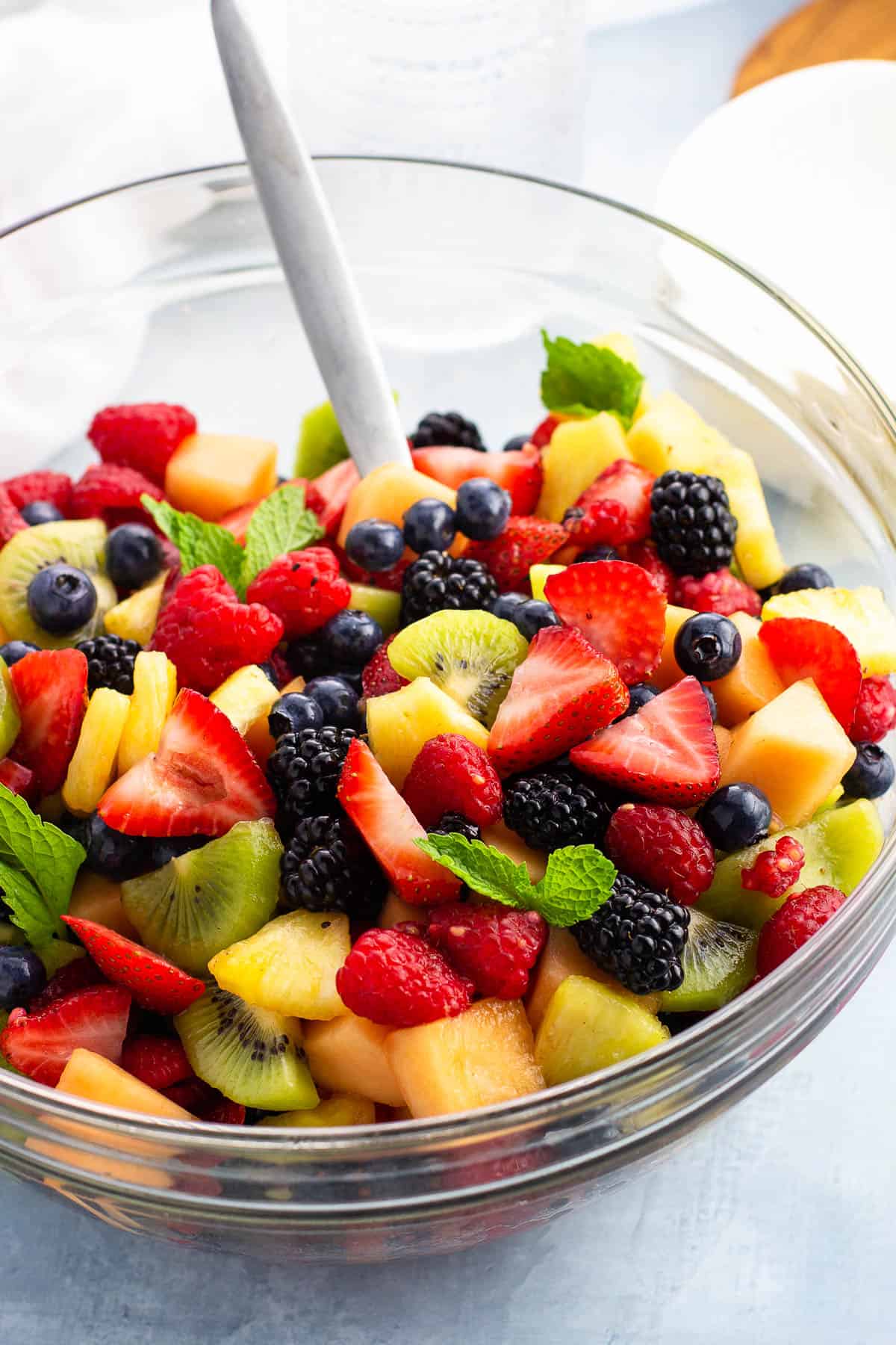 Fruit salad with anise and cinnamon syrup in a glass bowl.
