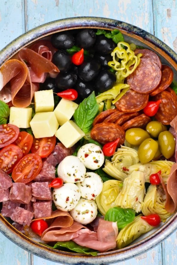 Serving dish of sandwich meat, cheese, and veggies.