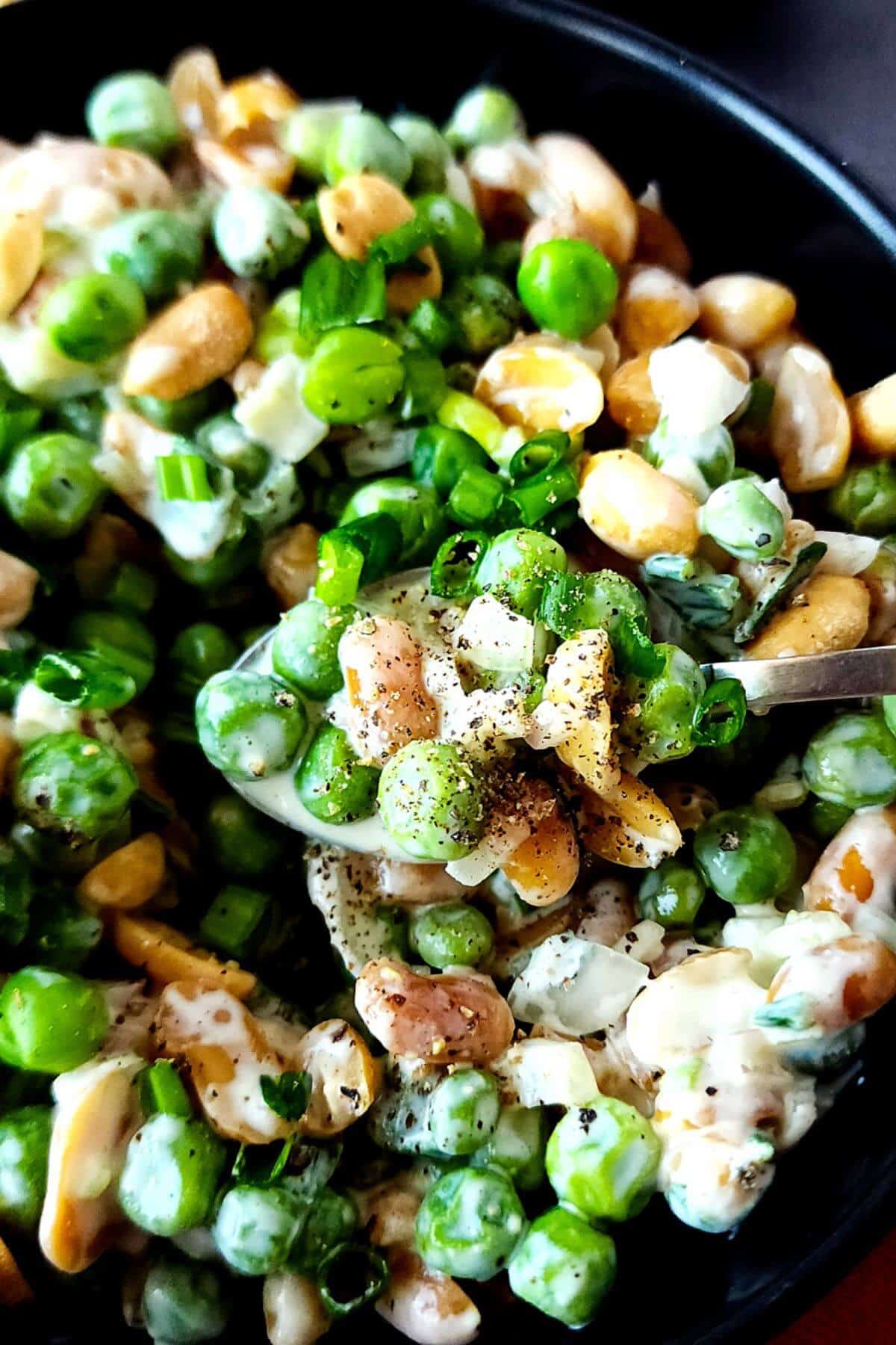 Pea and peanut salad in a serving bowl.