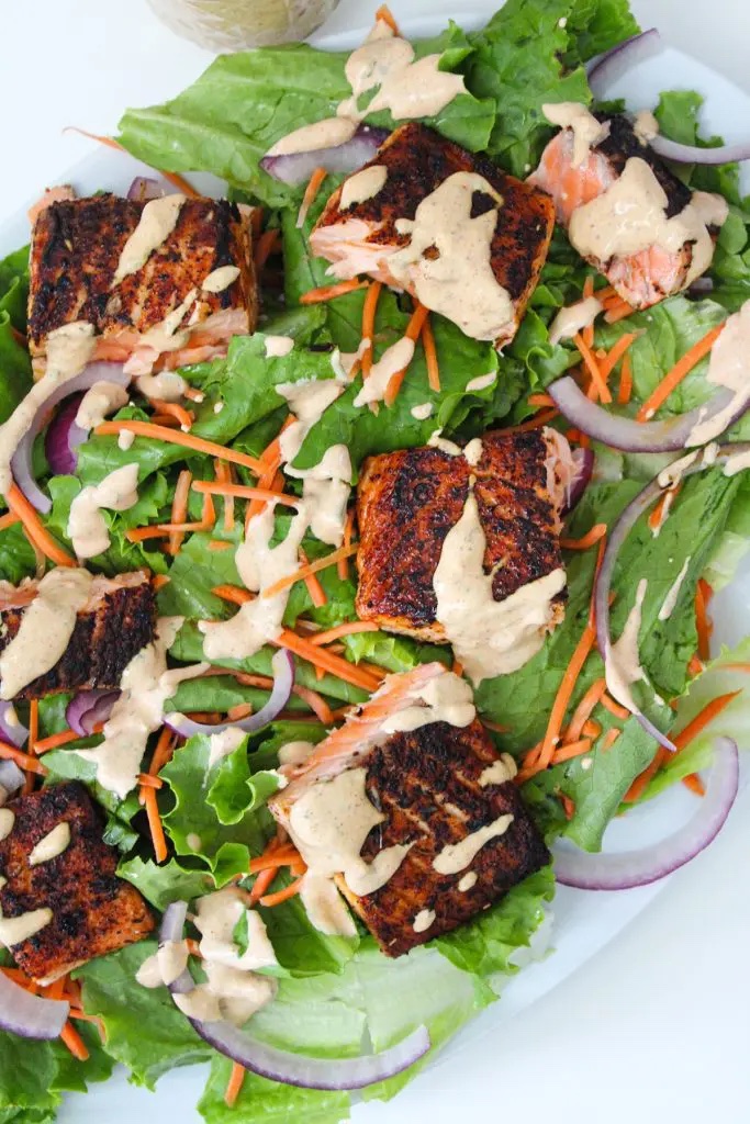 Spicy cajun salmon salad on a white serving plate.
