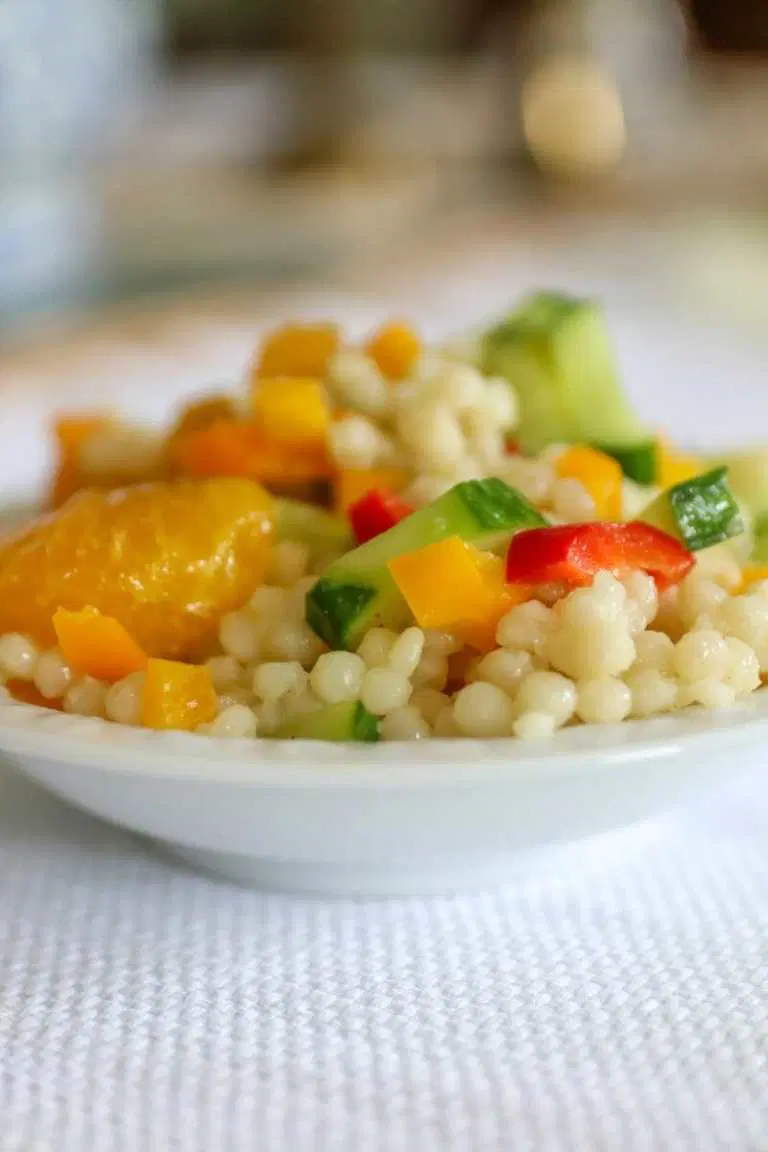 Summer couscous salad in a white bowl.