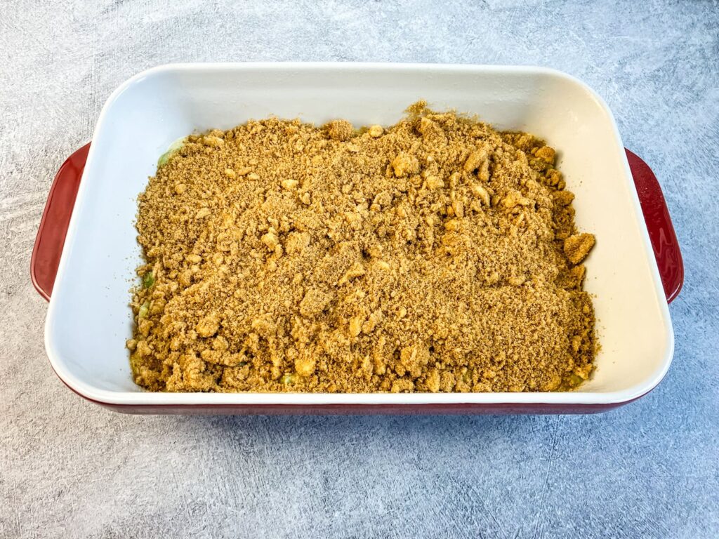 Baking dish or rhubarb coffee cake with the streusel topping ready to bake.