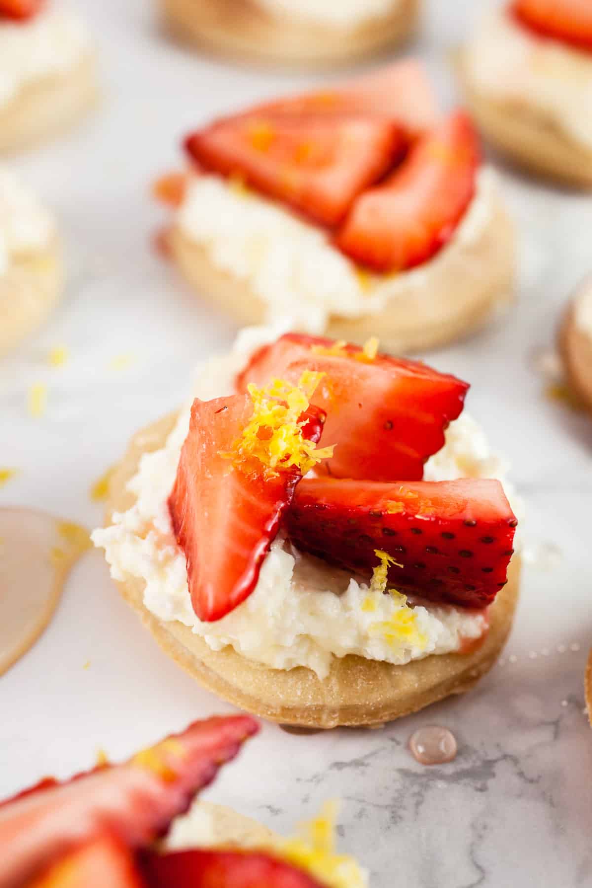 Strawberry mascarpone tartlets with fresh strawberries on top.