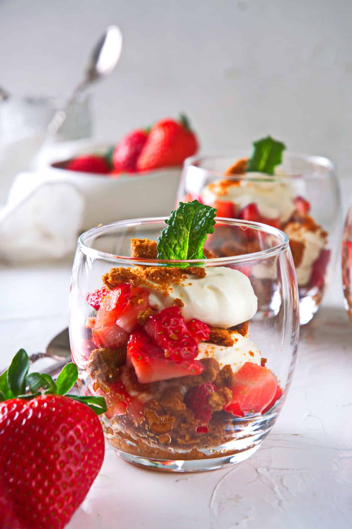 Strawberry parfaits in a glass cup.