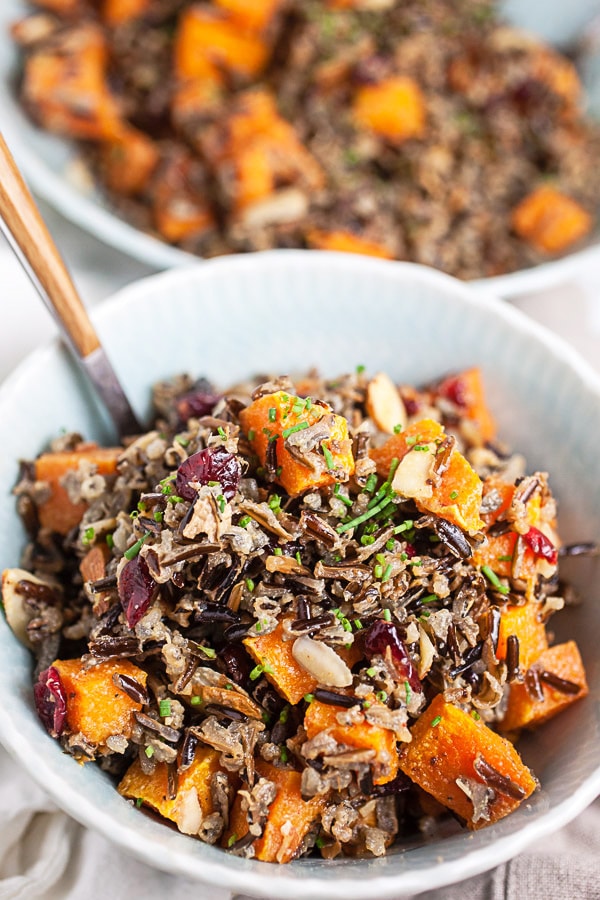 Butternut squash and wild rice salad in a white bowl.