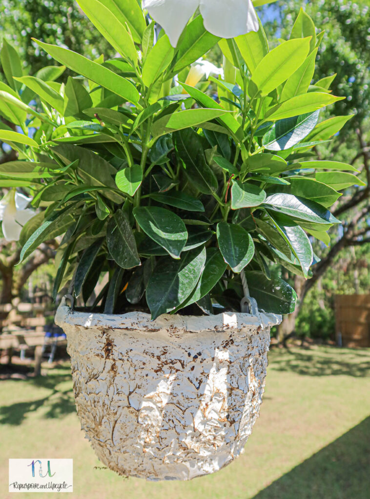 A white faux stone planter hanging basket.