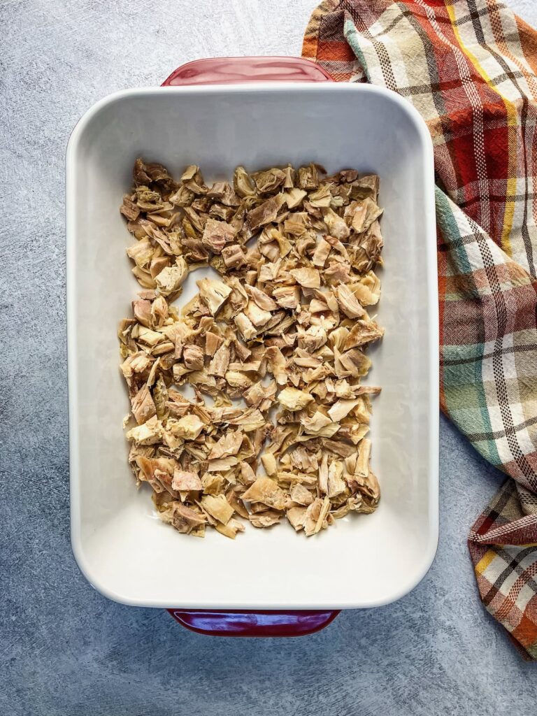Cooked and chopped turkey in a casserole dish.