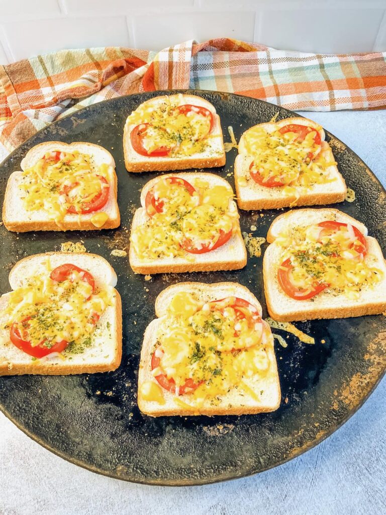 Garlic toast with tomatoes and cheese warm from the oven.