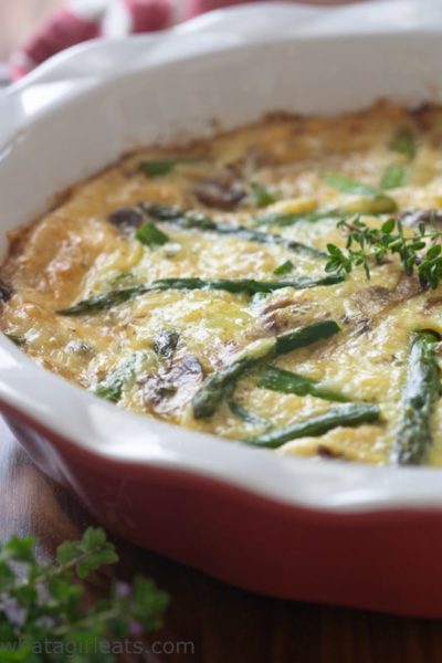 Asparagus quiche in a red baking dish.