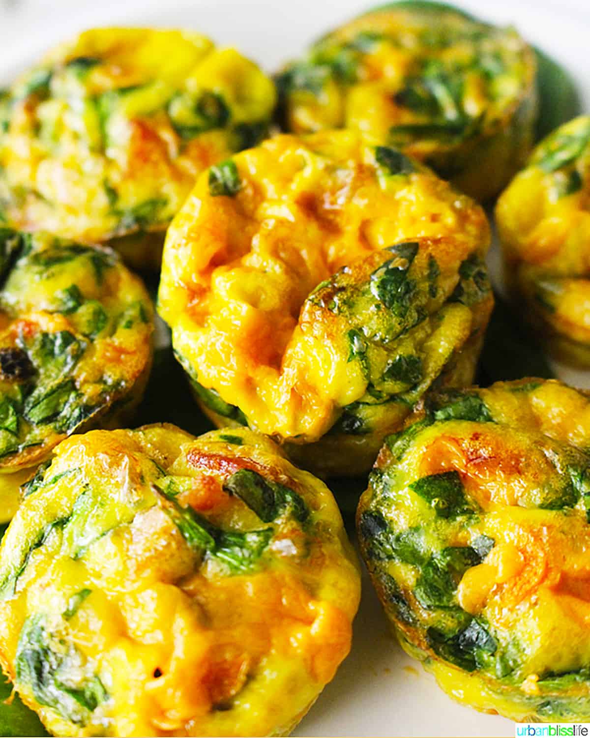 Cheese and spinach frittatas on a serving plate.