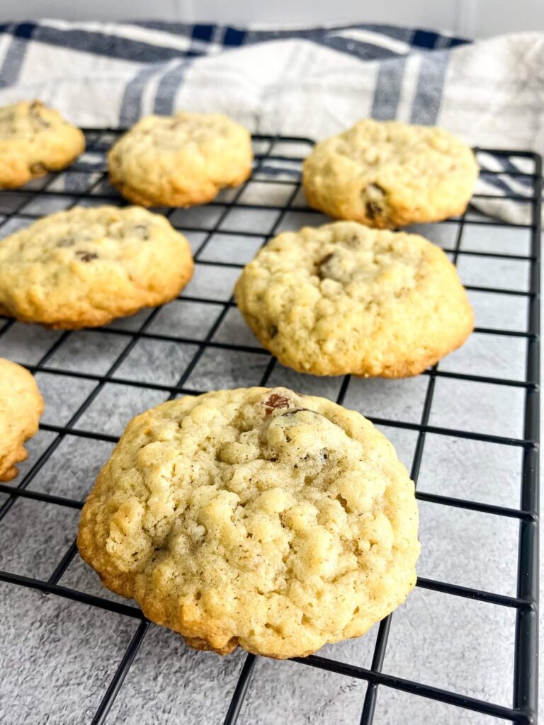 Homemade oatmeal raisin cookies cooling on a wire rack.
