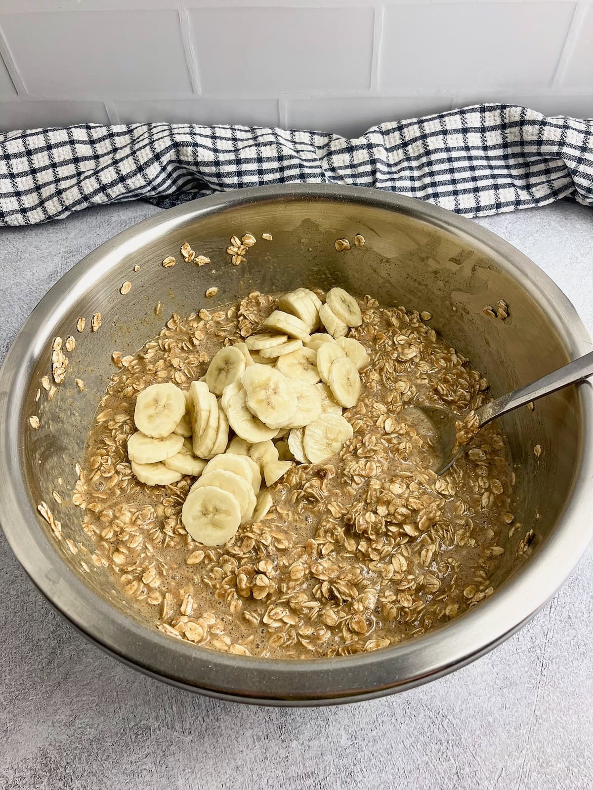 Sliced bananas are added to the baked oatmeal batter.