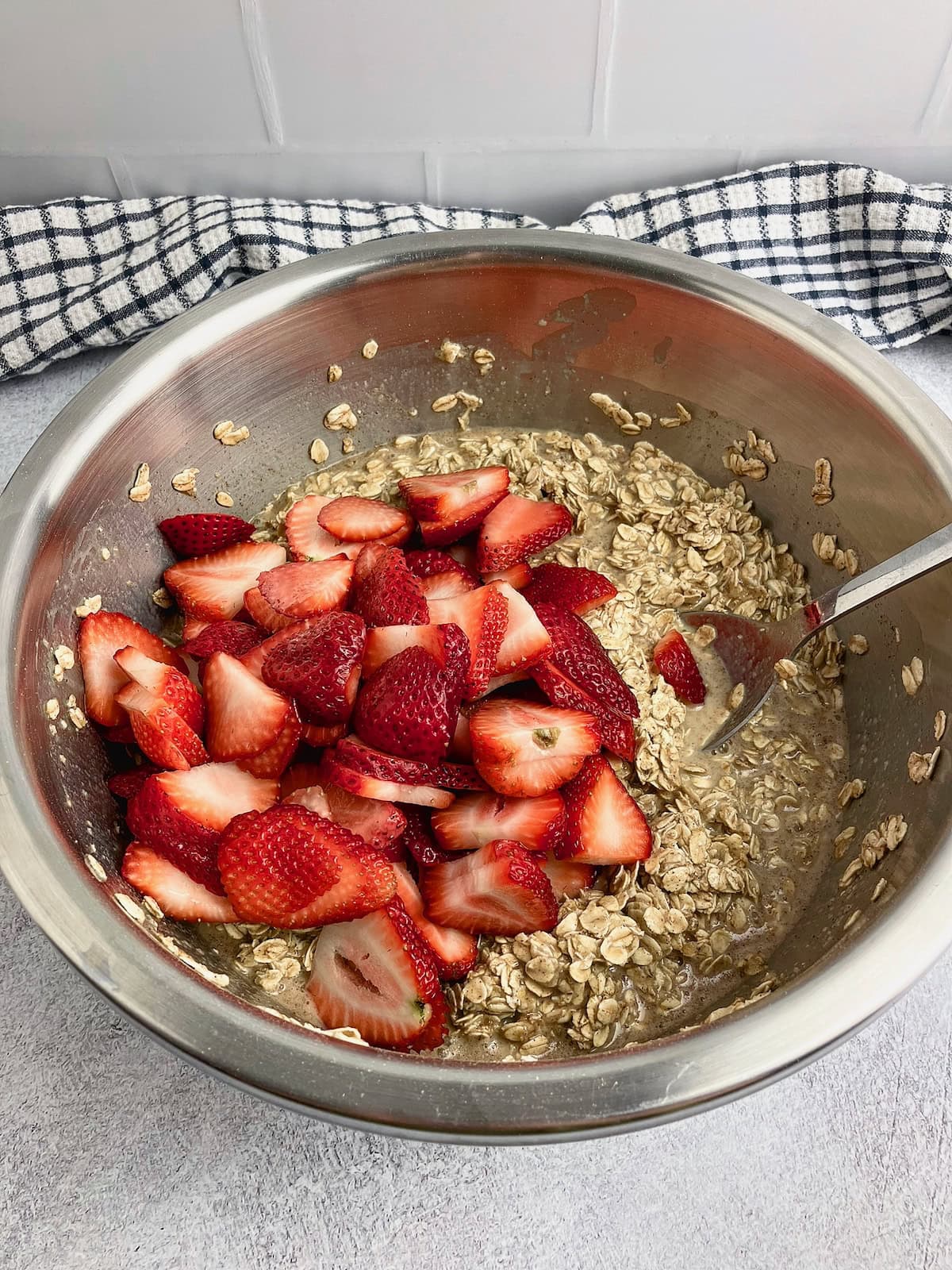 Sliced strawberries were added to the bowl.