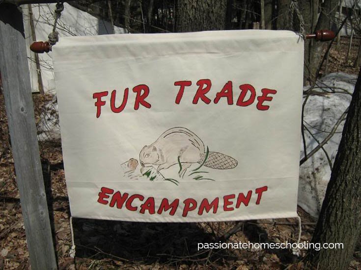 Sign with a beaver drawing, text says Fur Trade Encampment.
