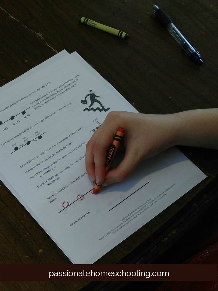 Child working on music worksheets.