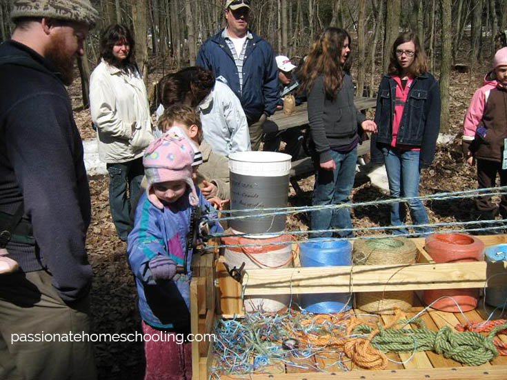Young child making rope.