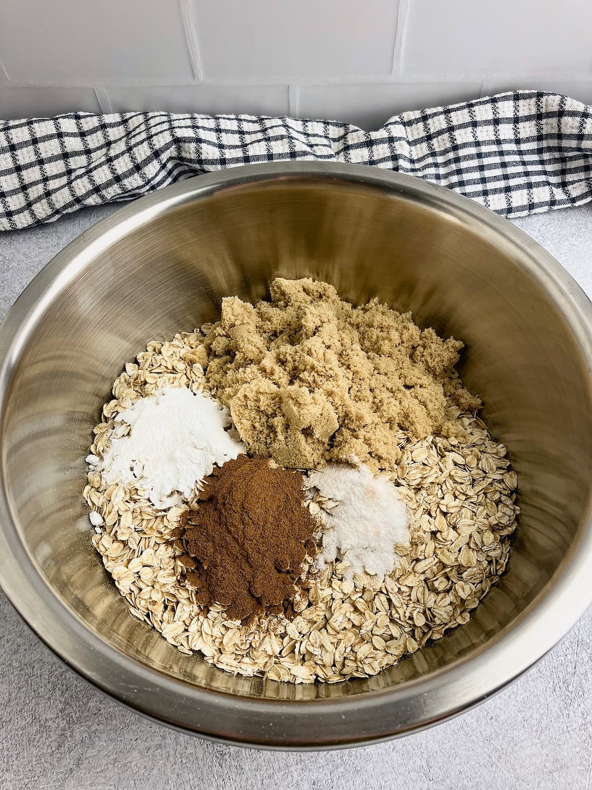 Oats, brown sugar, salt, baking powder, and cinnamon in a mixing bowl.