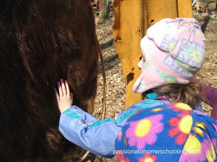 Young child touching processed fur skins.
