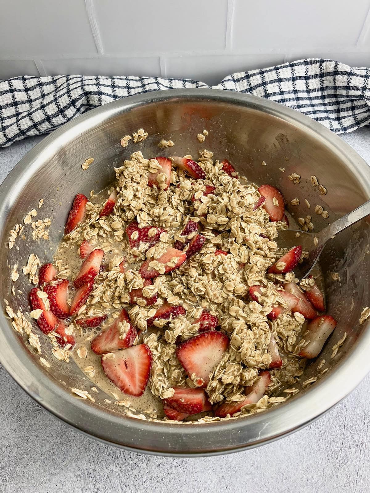 The sliced strawberries are folded into the oatmeal batter.