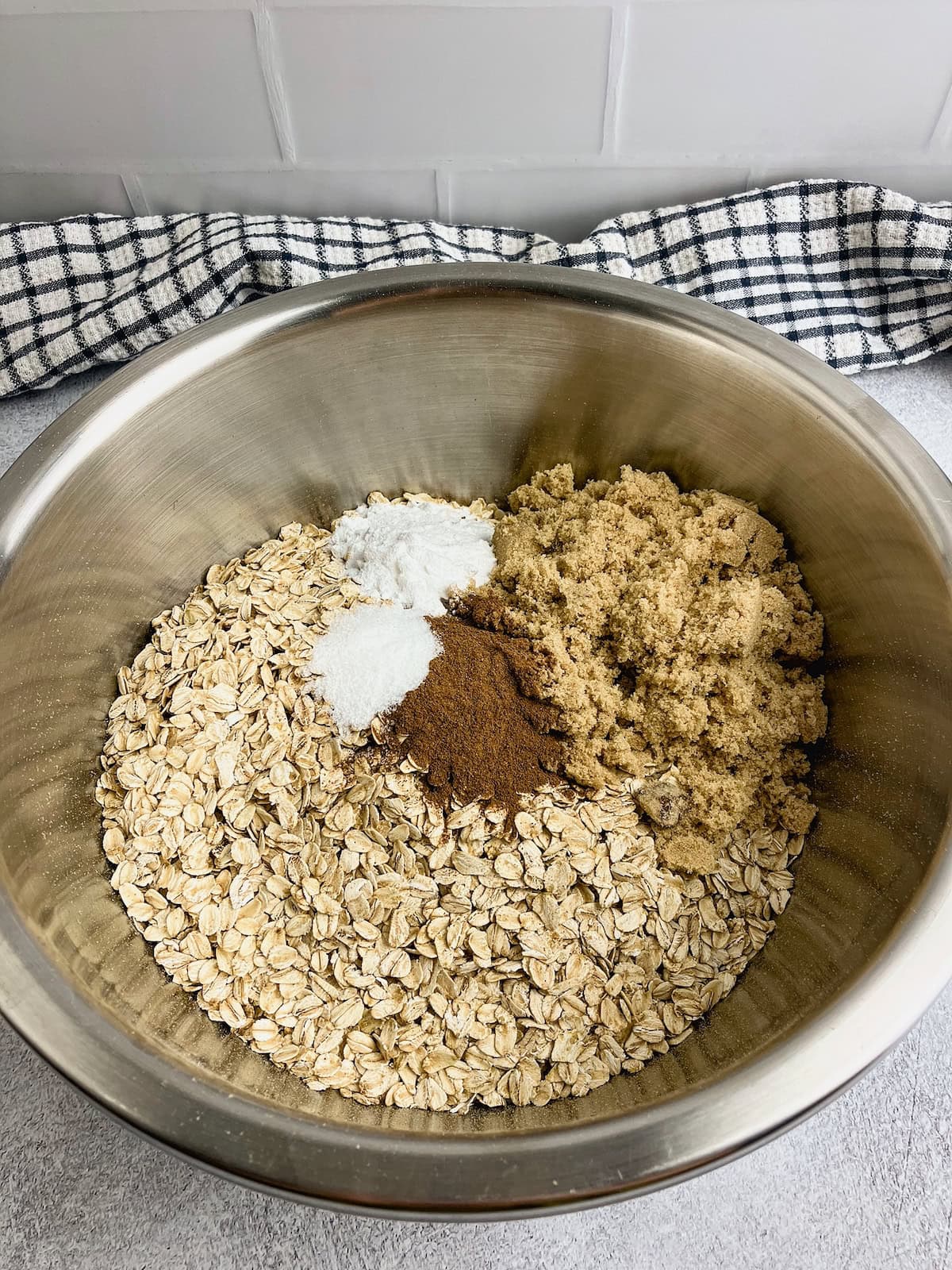 Oats, brown sugar, cinnamon, salt, and baking powder in a mixing bowl.