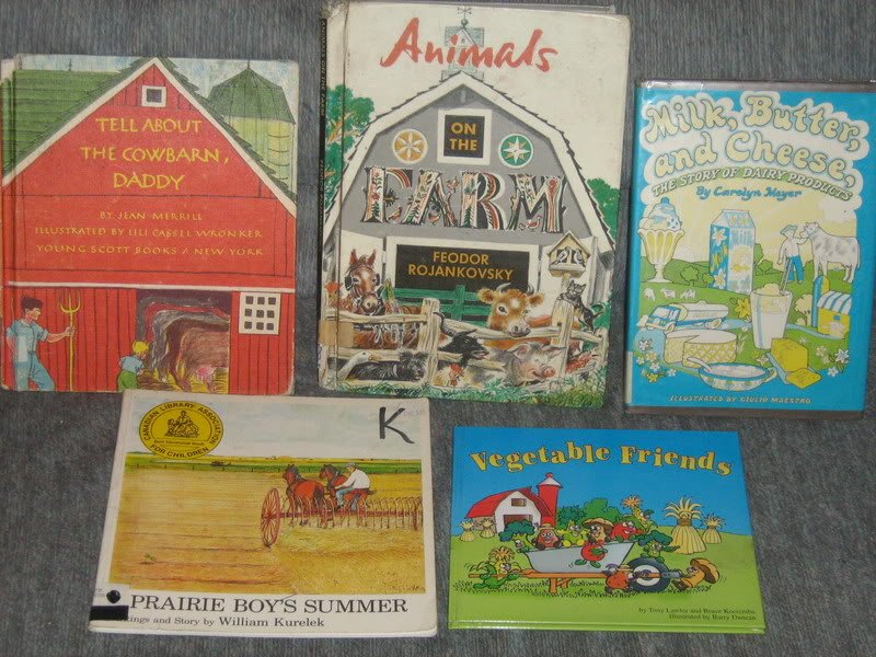 Farm themed kids books laying on a couch.