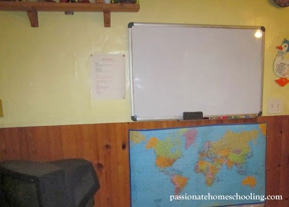 Large world map and whiteboard on the wall.