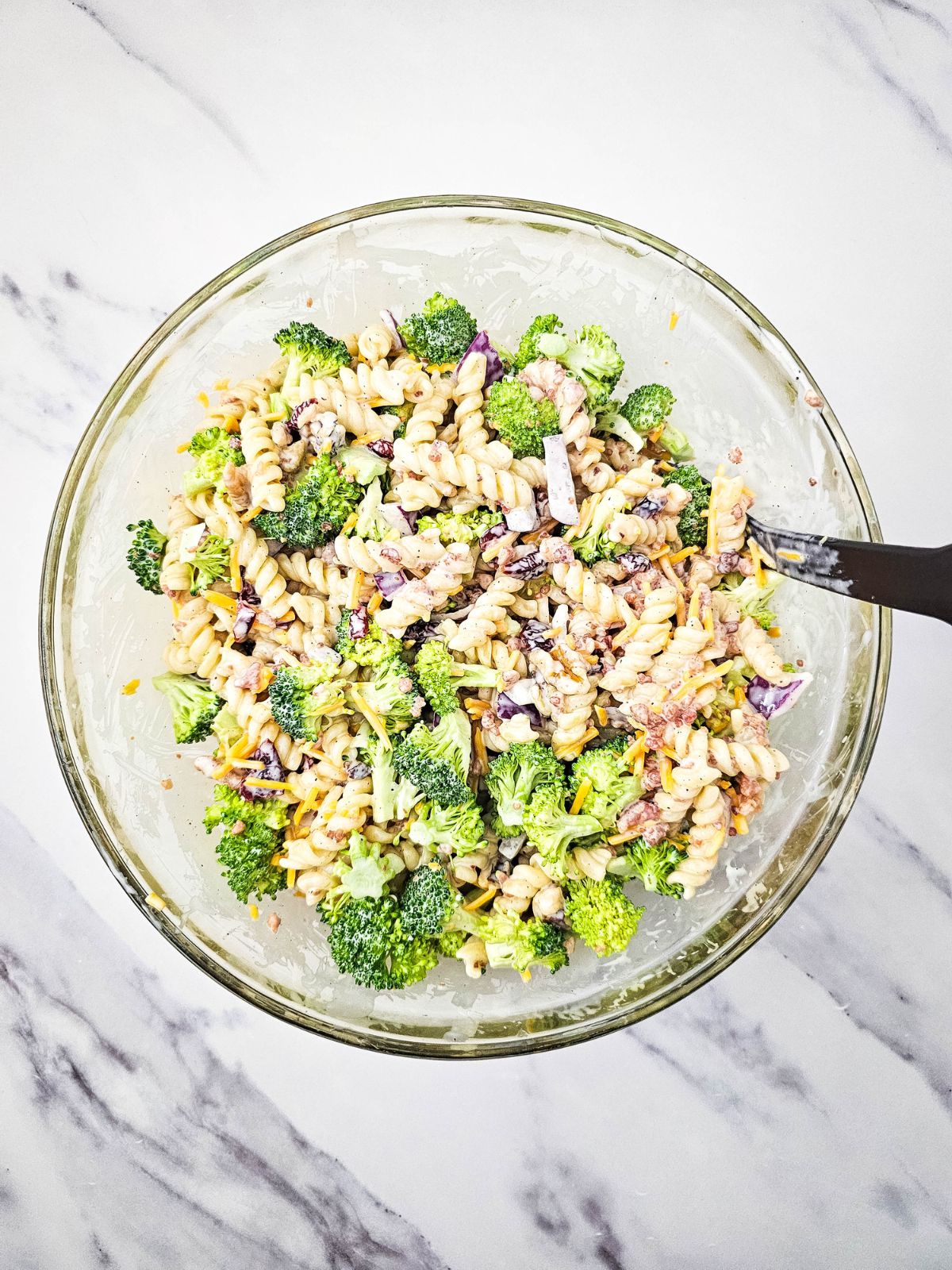Broccoli pasta salad is mixed together.