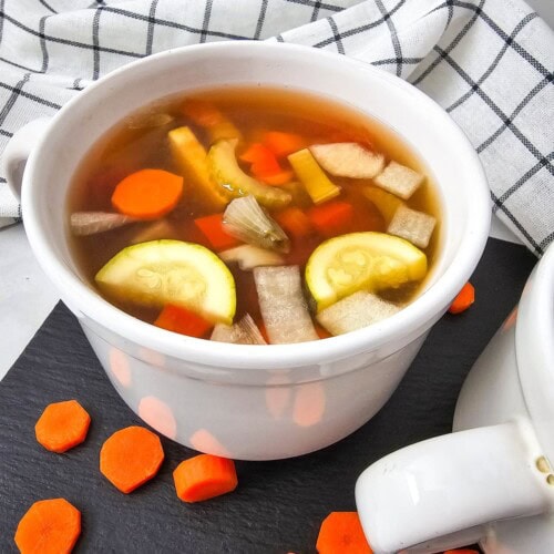 A soup mug of homemade crockpot summer vegetable soup.