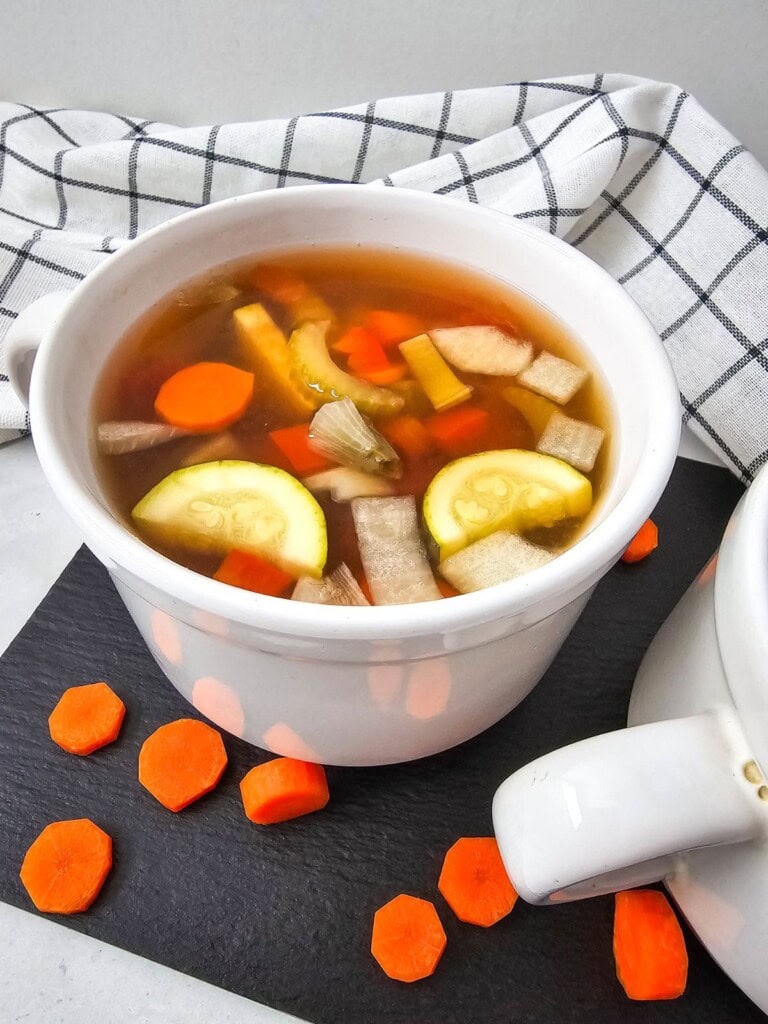 A soup mug of homemade crockpot summer vegetable soup.