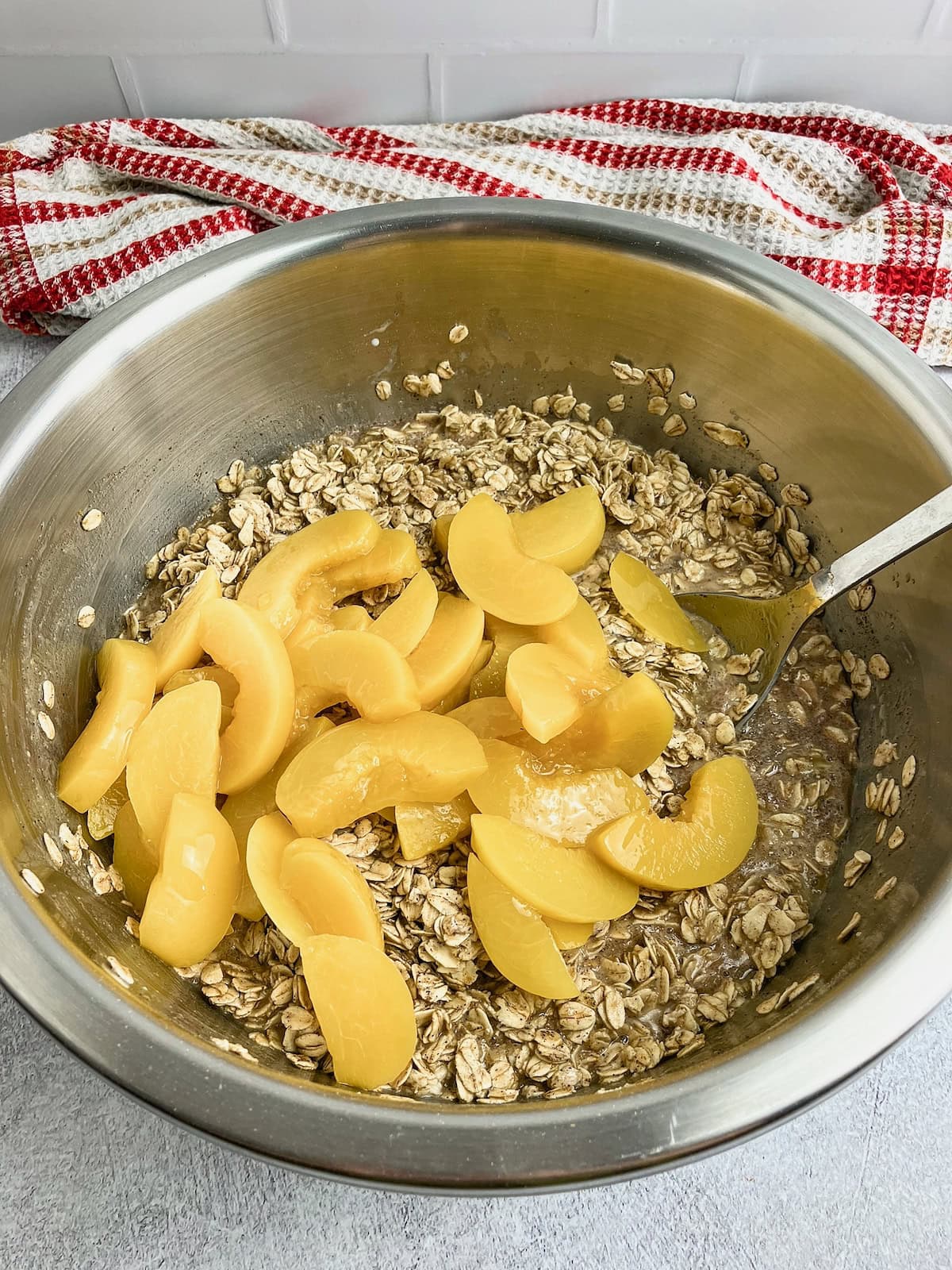 Sliced peaches are added to the oatmeal batter.