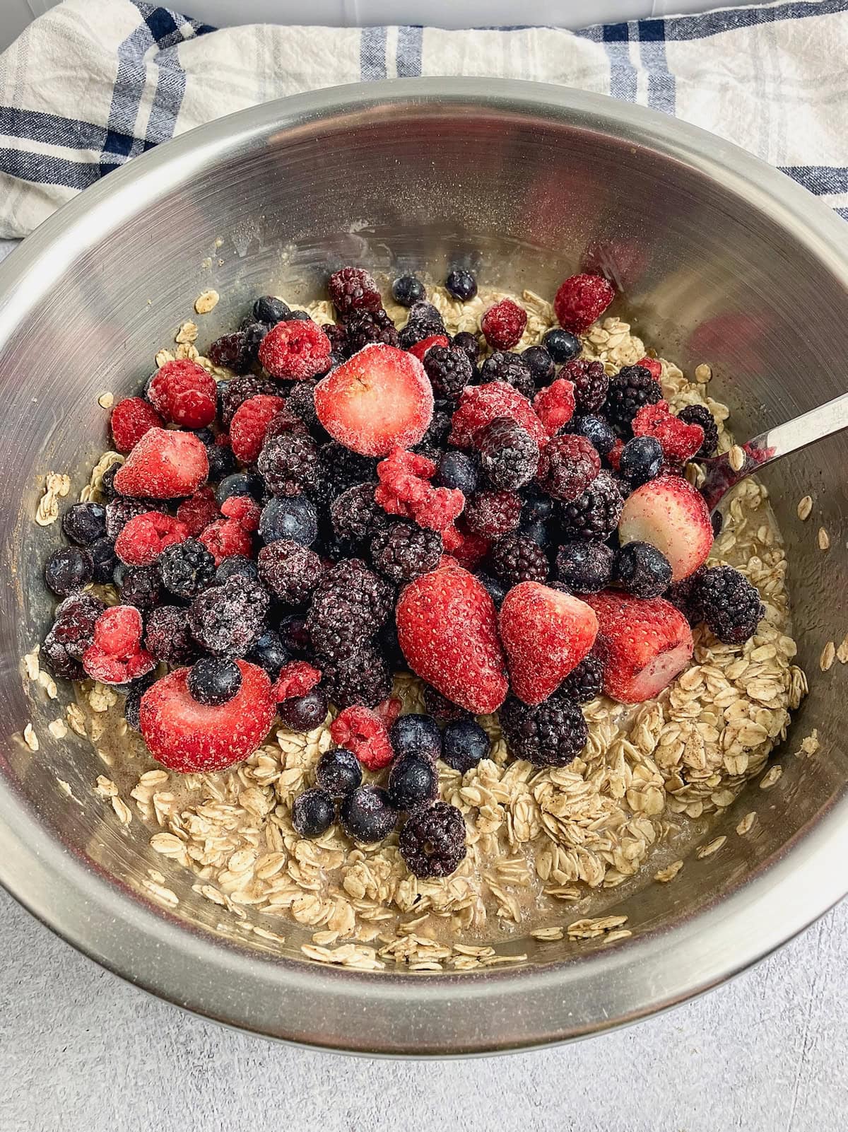 Frozen mixed berries are added to the oatmeal batter.