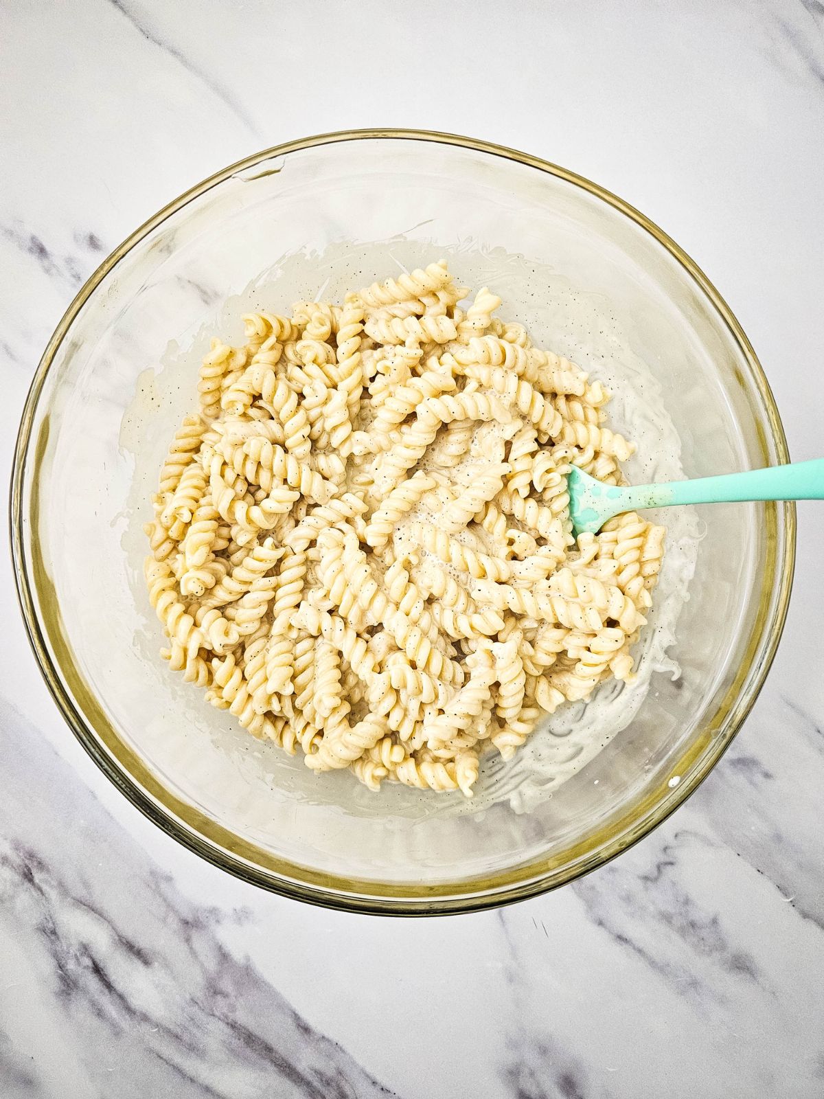 Pasta and dressing mixed together.