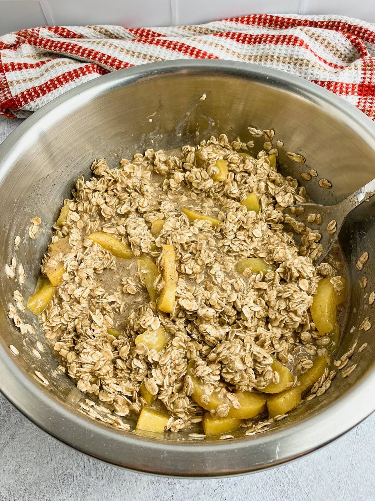 Peach baked oatmeal batter mixed together in a bowl.