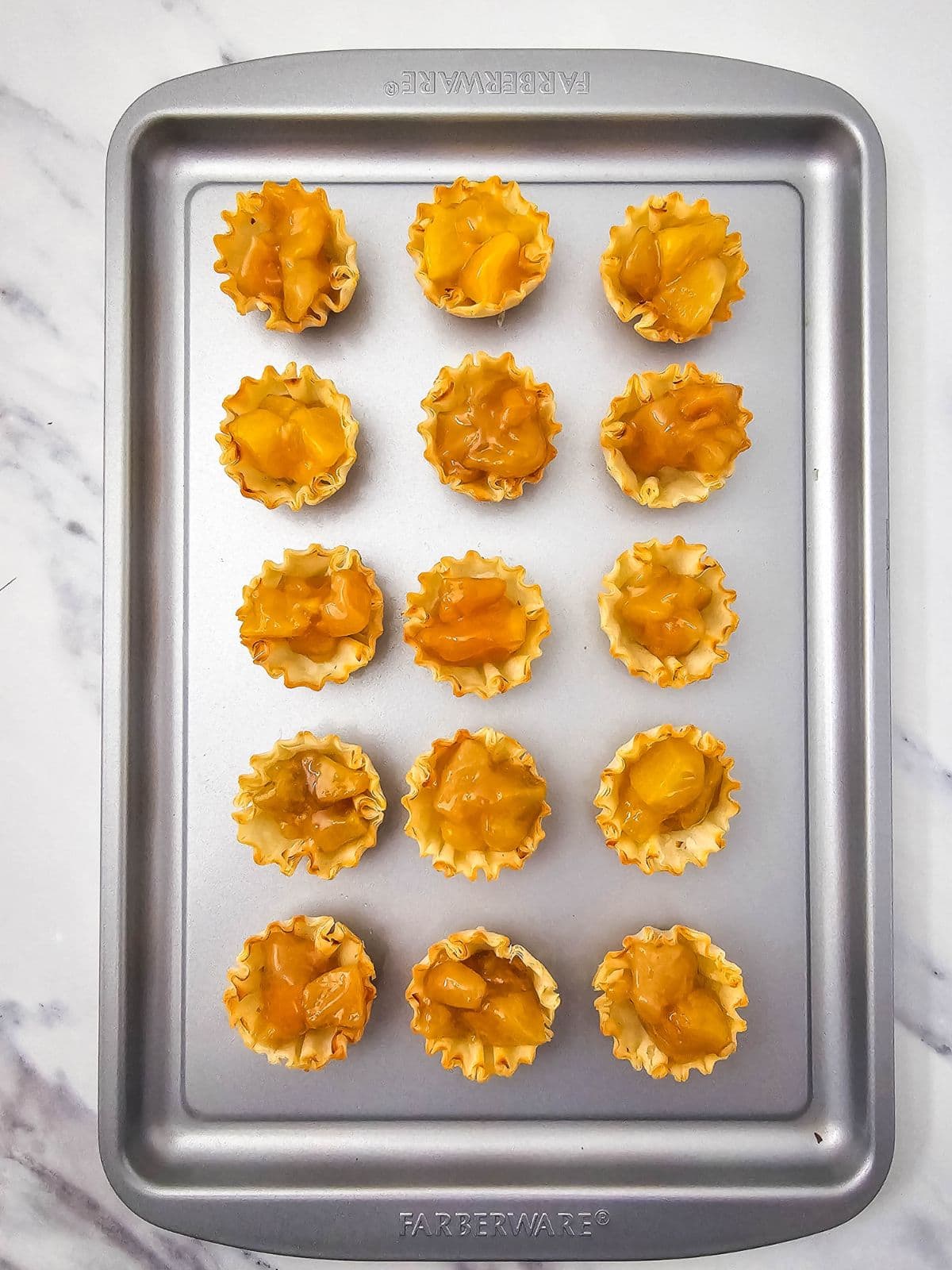 Phyllo shells filled with peach pie filling.