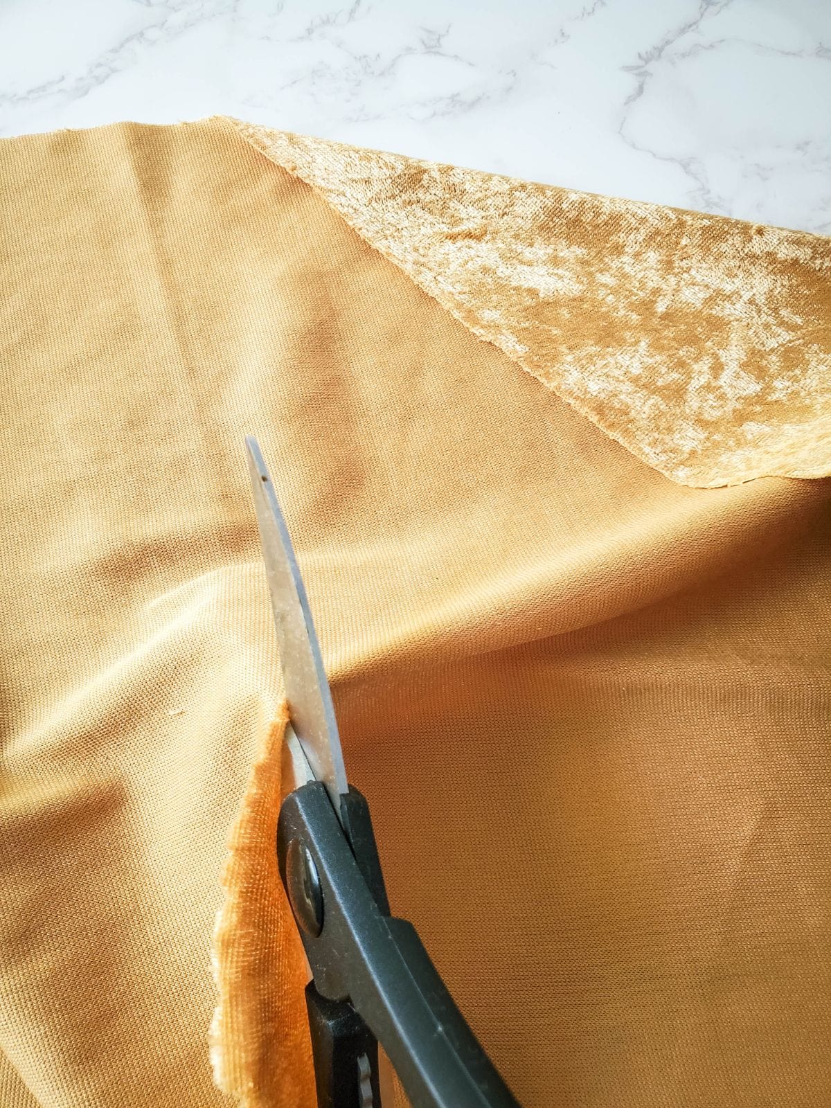 Cutting the velvet cloth with scissors.
