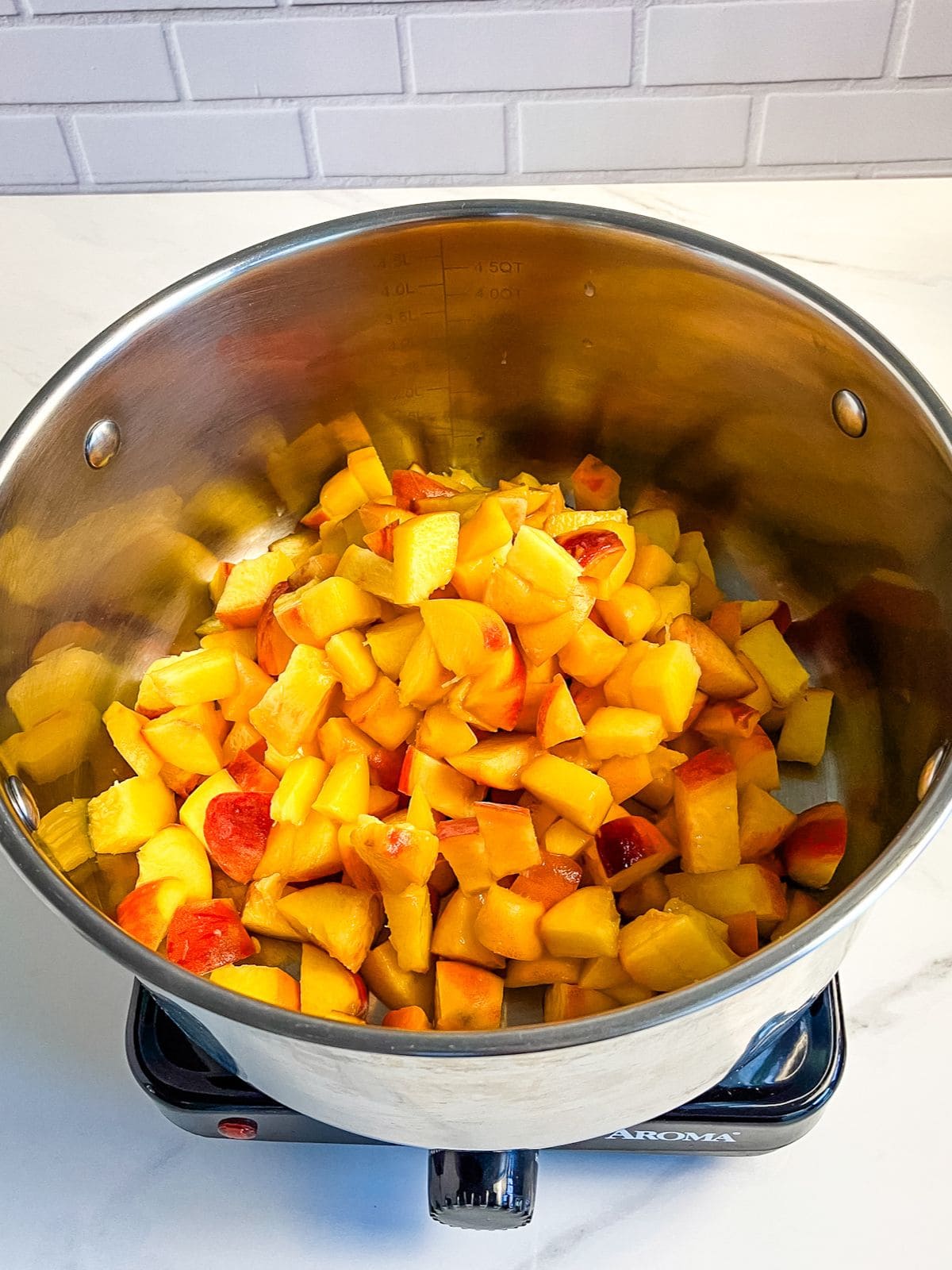 Diced peaches in a large pot.