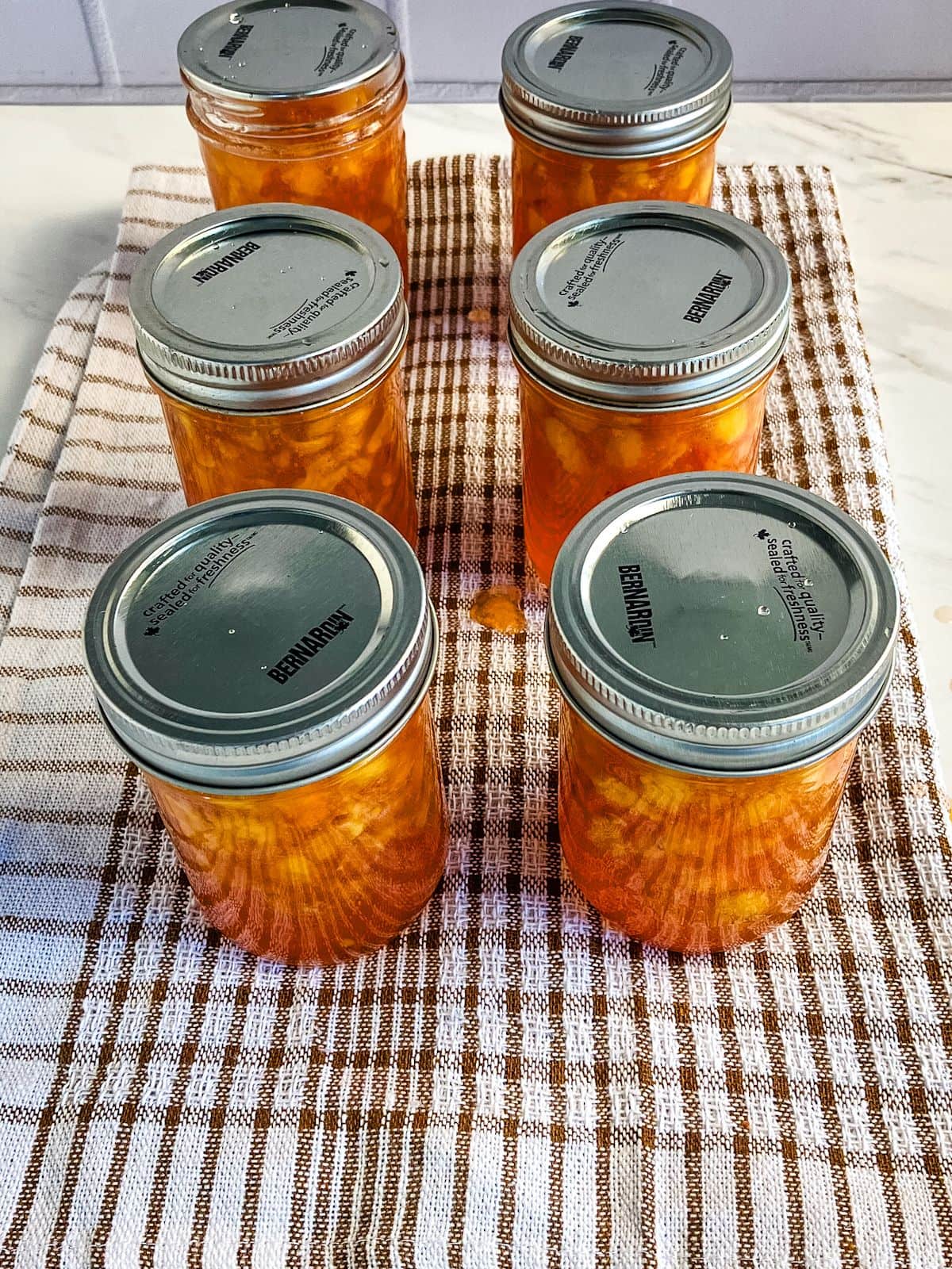 Lids and jar rings have been added to the jam jars.