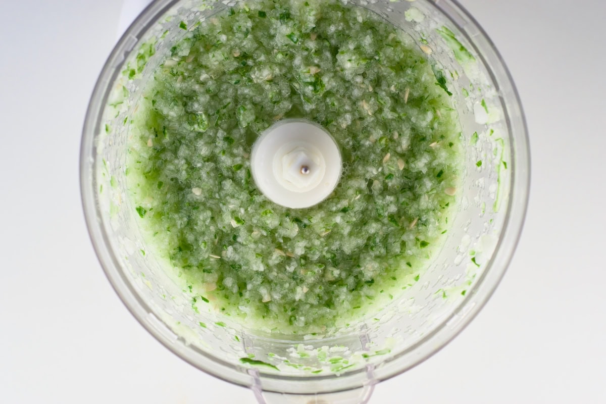 Pureed cucumbers in a food processor bowl.