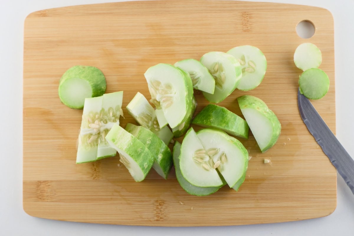 Sliced cucumbers on a cutting board.