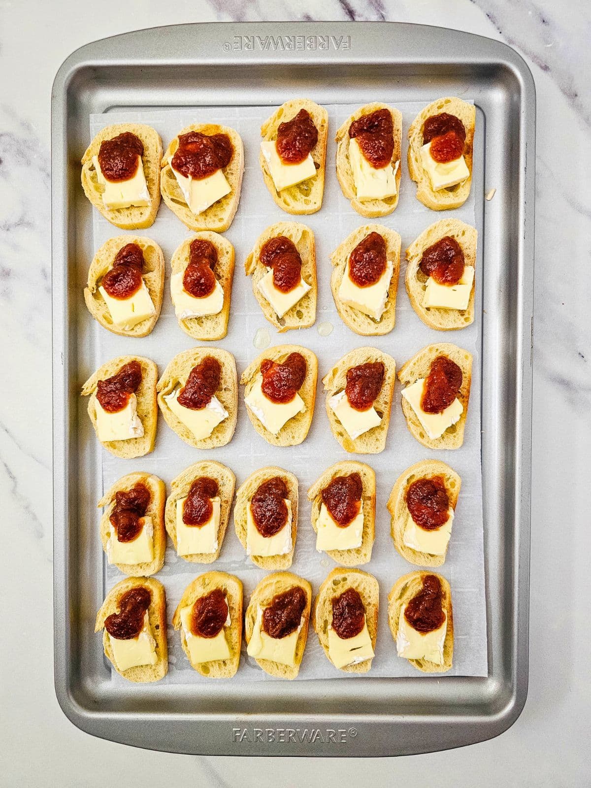 Apple butter and brie spread on the toasted baguette slices.
