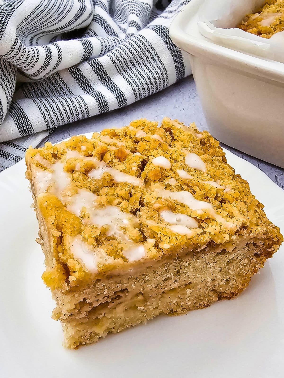 Easy apple crumb cake sliced on a white plate.