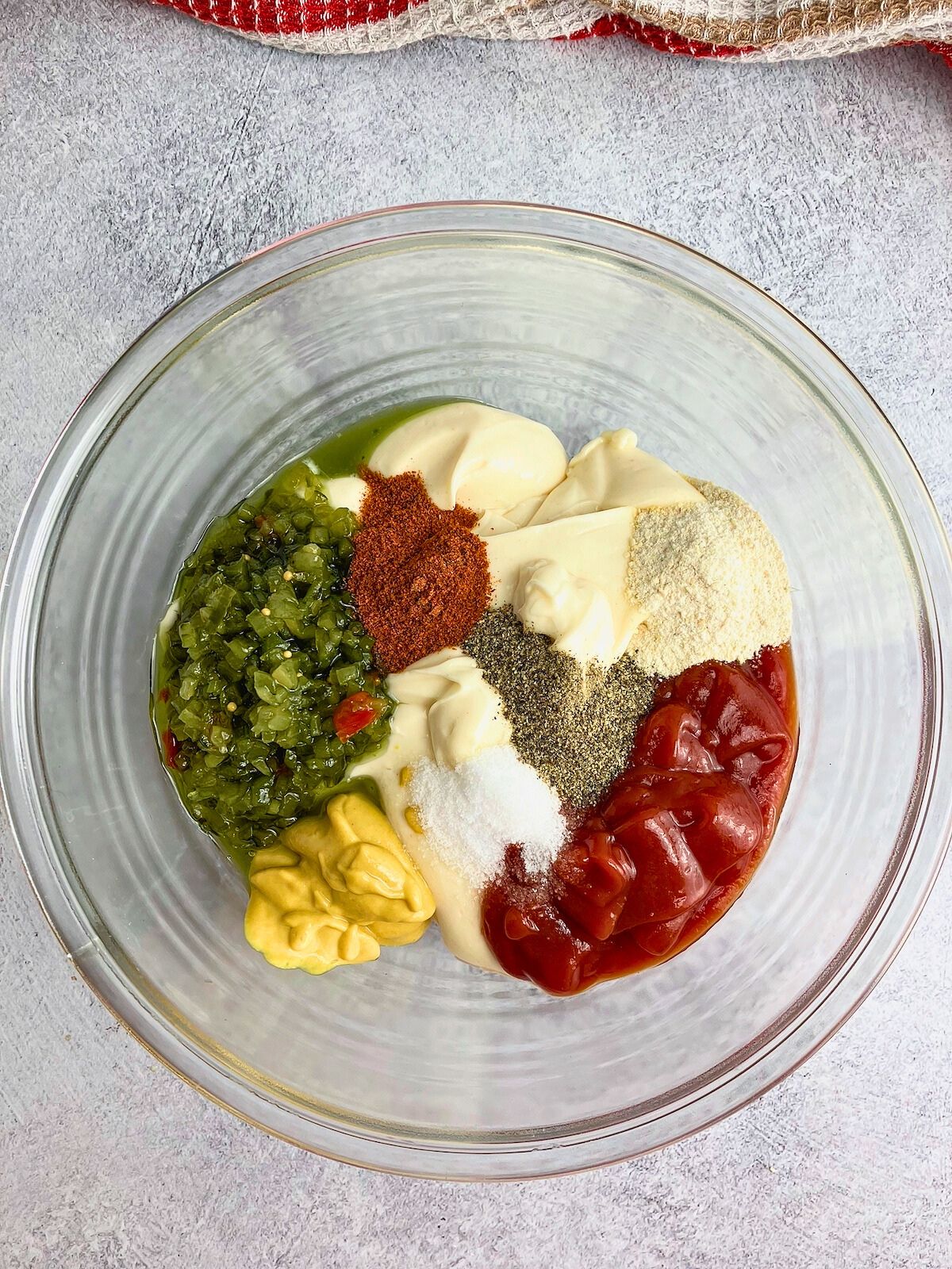 Ketchup, sweet relish, mustard, and seasonings are added to the sauce.