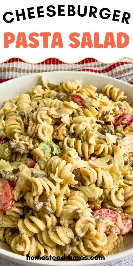 A white serving bowl of cheeseburger pasta salad. The text overlay says Cheeseburger Pasta Salad.