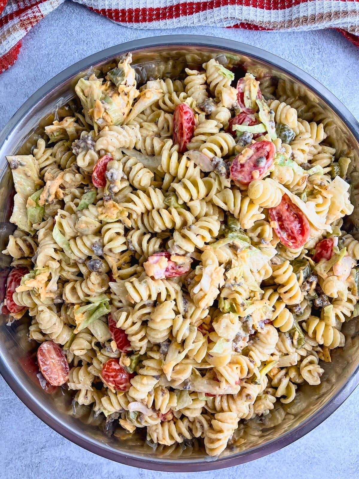 Cheeseburger pasta salad mixed together in a large bowl.